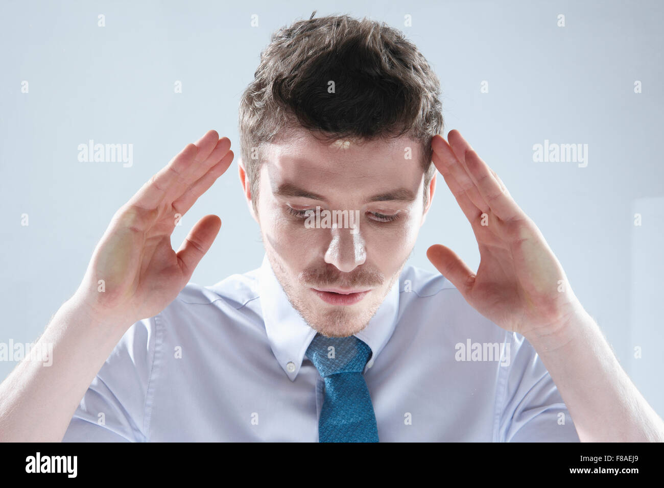 Man looking down through the glass window Stock Photo