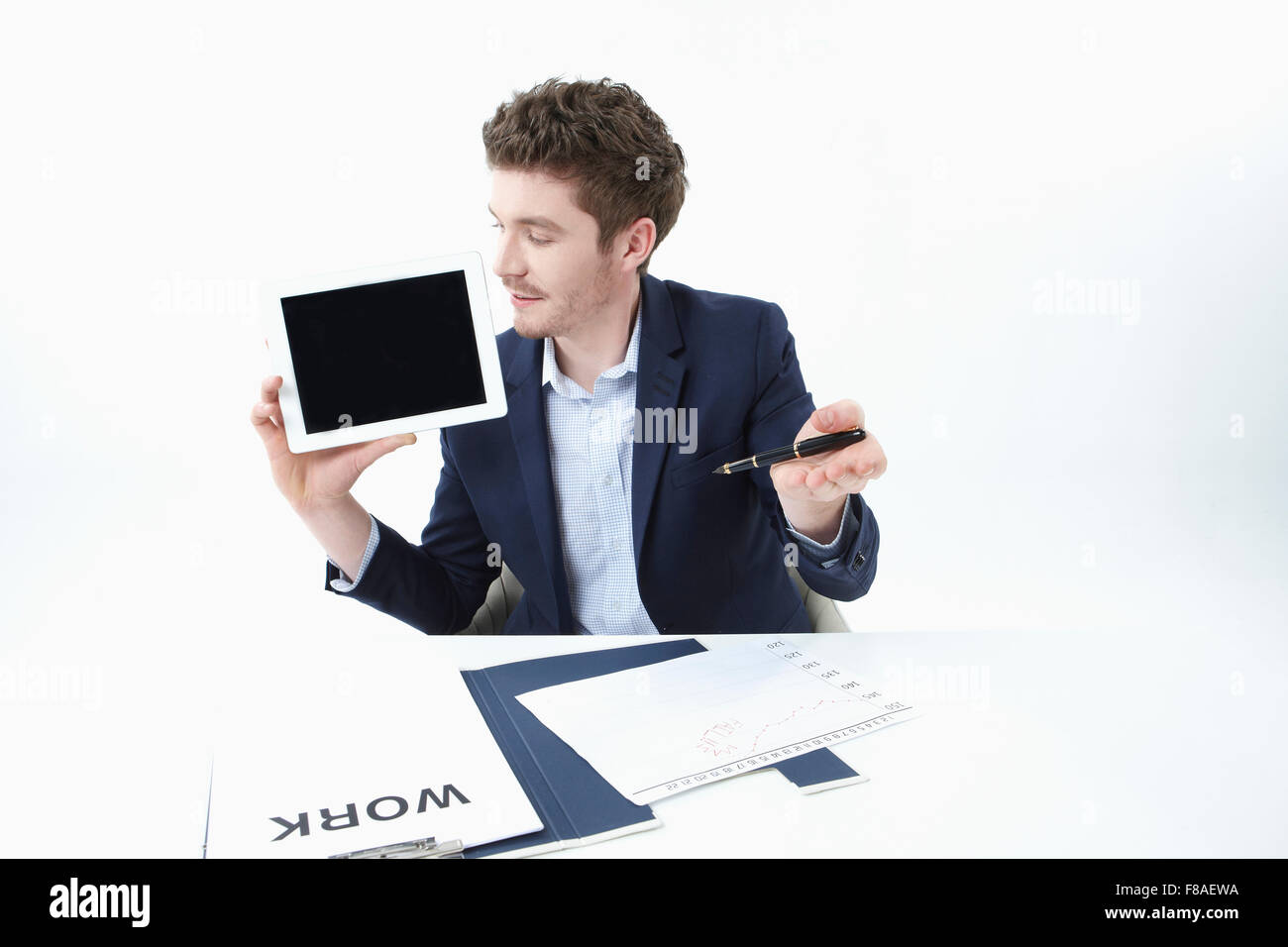 Businessman holding and looking at the tablet PC with hand gesture Stock Photo