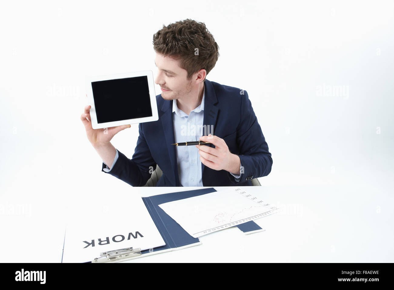 Man holding a tablet PC and looking at it Stock Photo