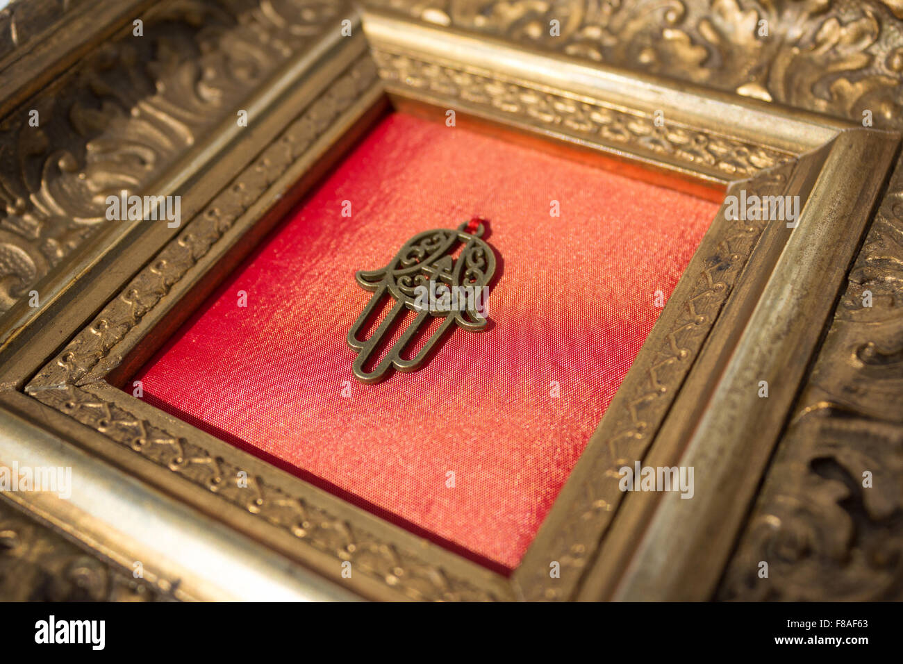 hand of fatima in decorative golden frame Stock Photo