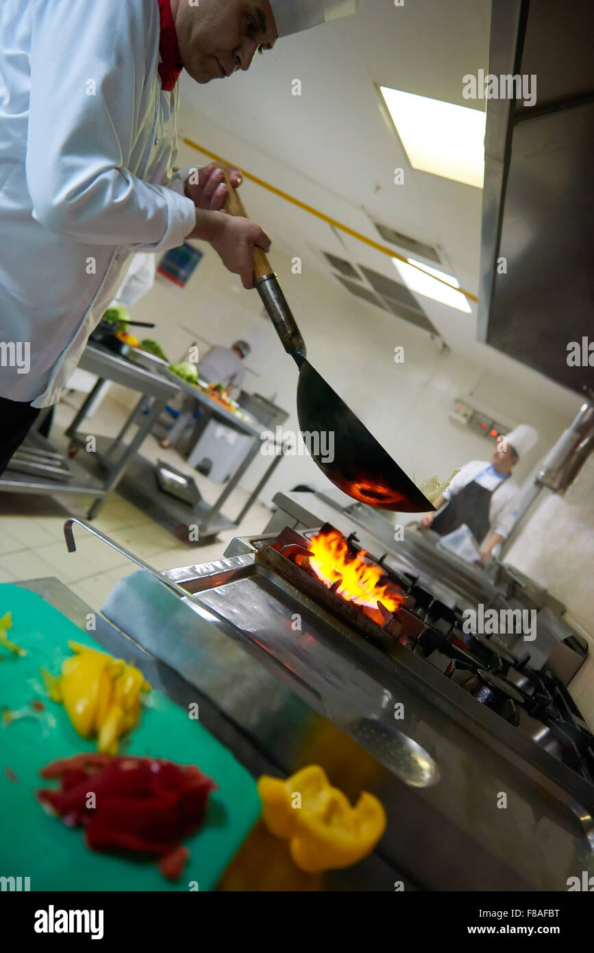 chef in hotel kitchen prepare vegetable food with fire Stock Photo - Alamy