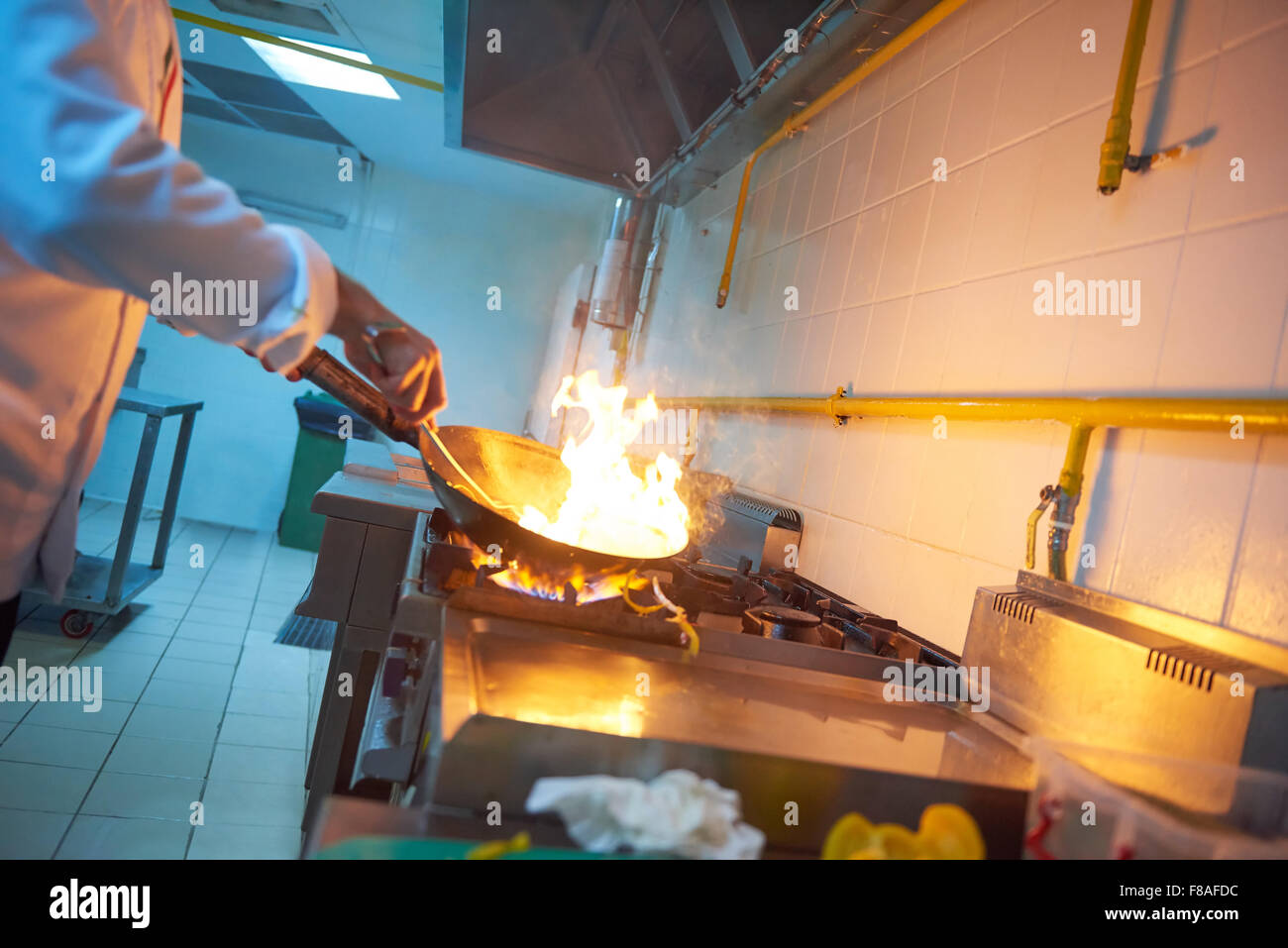 chef in hotel kitchen prepare vegetable food with fire Stock Photo - Alamy