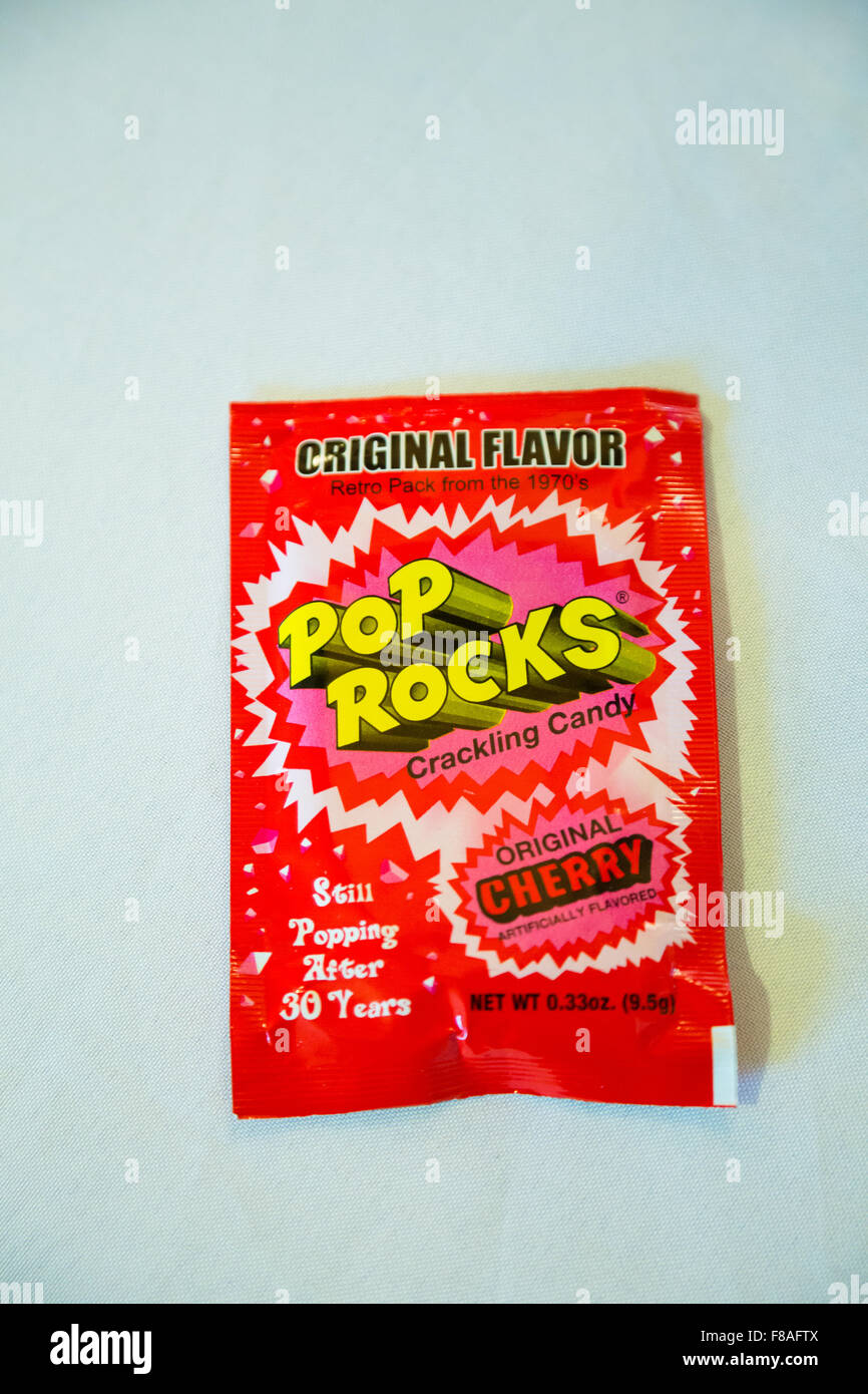 TUALATIN, OR - OCTOBER 4, 2014: Cherry flavor Pop Rocks candy on a white table cloth. Stock Photo