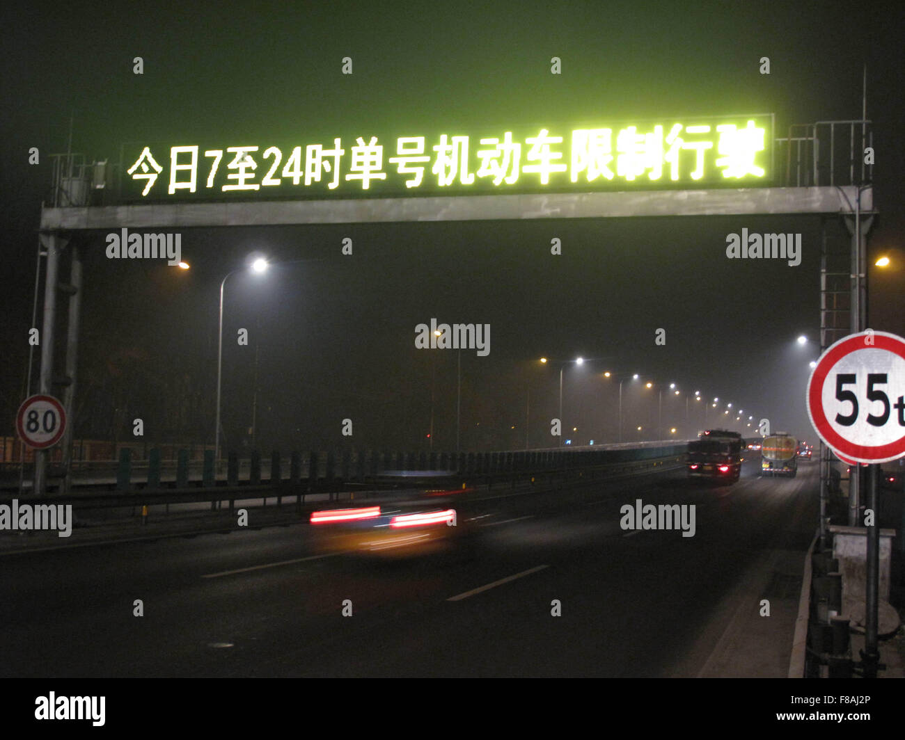 Beijing, China. 08th Dec, 2015. An electronic road sign reminds drivers to use cars on alternating days depending on the odd or even numbers of their license plates in Beijing, capital of China, Dec. 8, 2015. Beijing has issued its first red alert for air pollution under a four-tier emergency response system created in October 2013. The red alert, the most serious level, will last from 7 a.m. on Tuesday to noon on Thursday. Credit:  Xinhua/Alamy Live News Stock Photo