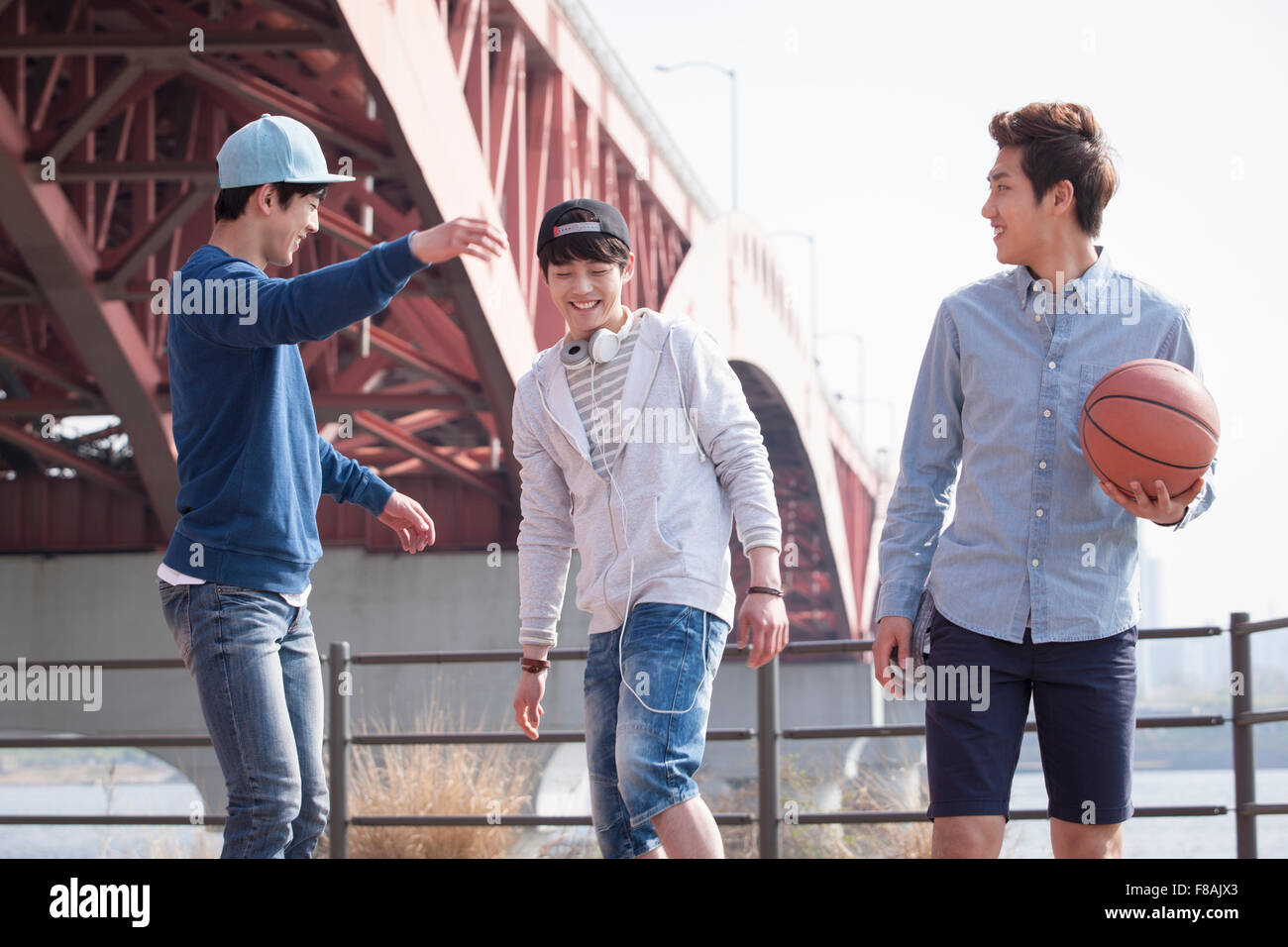 Three young men having fun under the bridge at Han river park Stock Photo