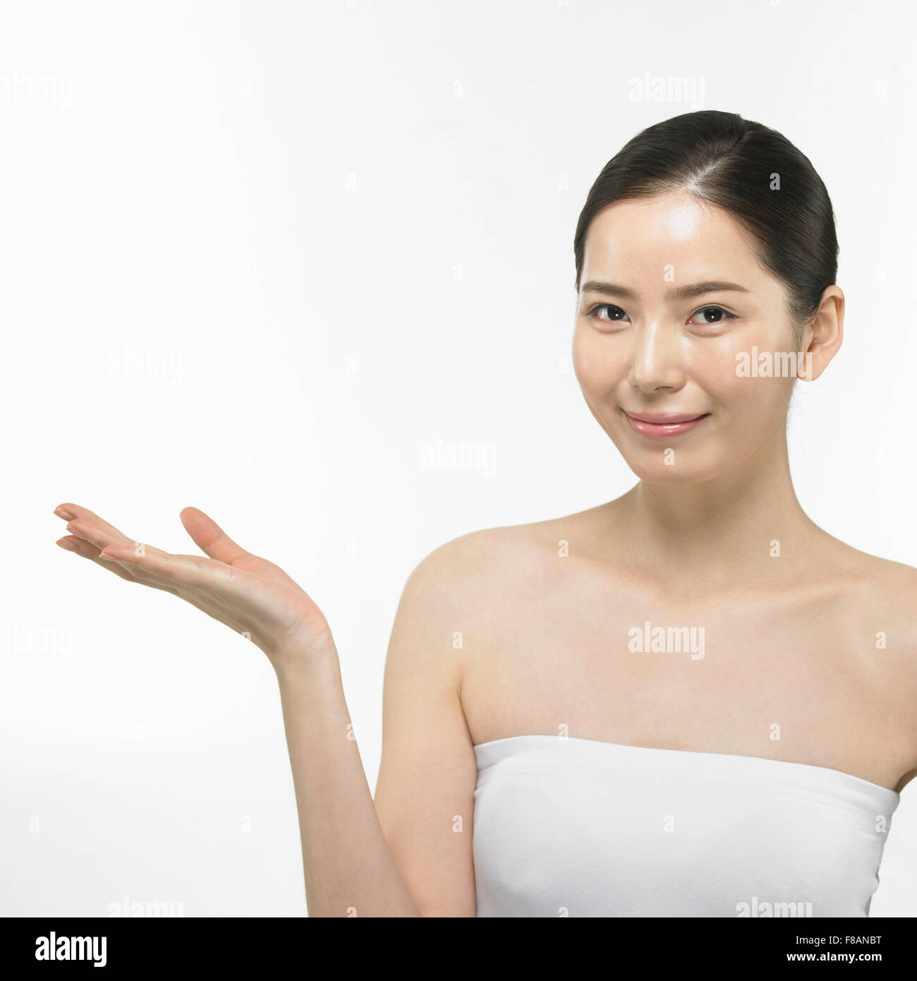 Portrait of smiling Korean woman holding hand staring at front Stock Photo