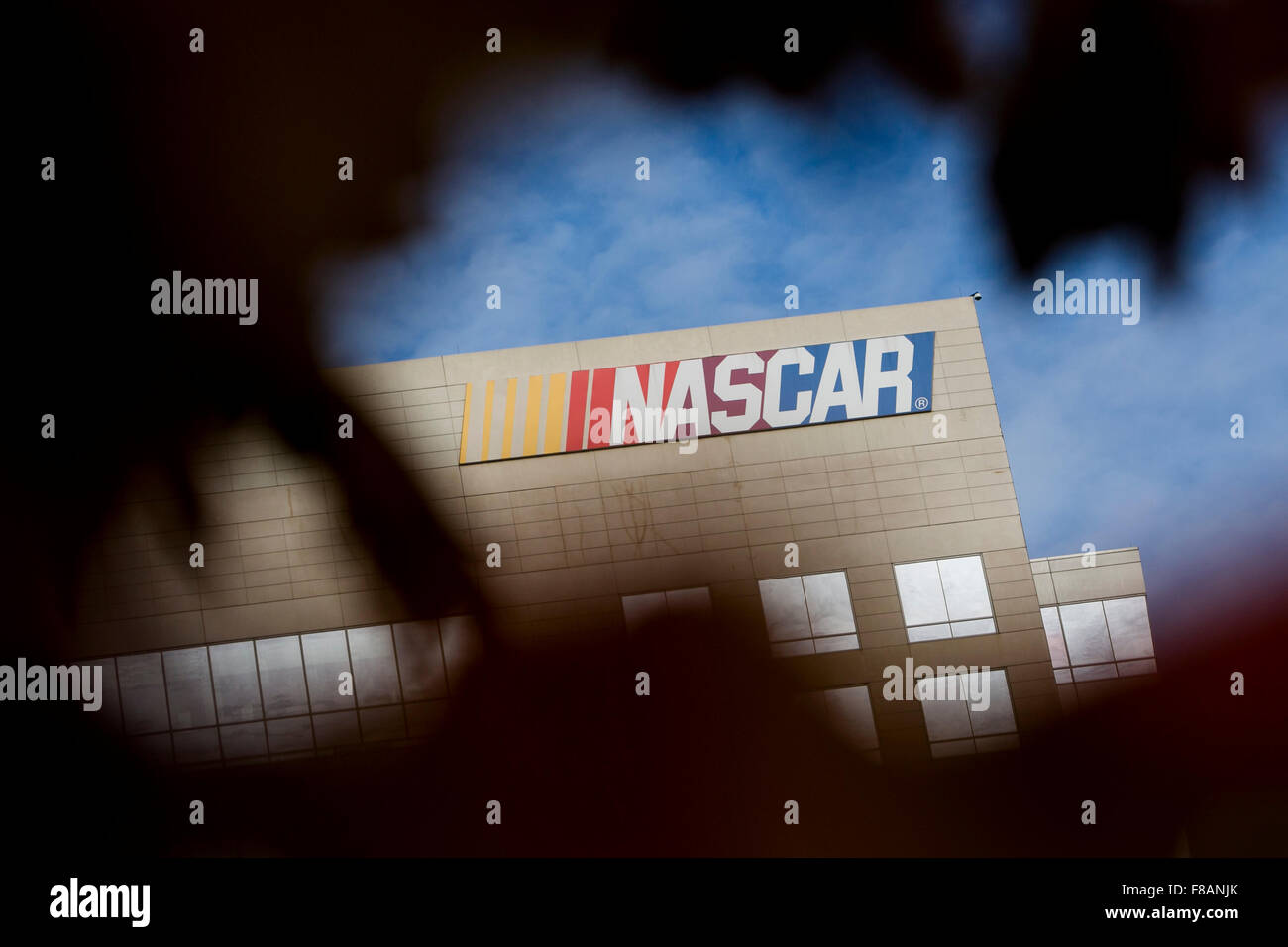 A logo sign outside of a facility occupied by the National Association for Stock Car Auto Racing (NASCAR) in Charlotte, North Ca Stock Photo