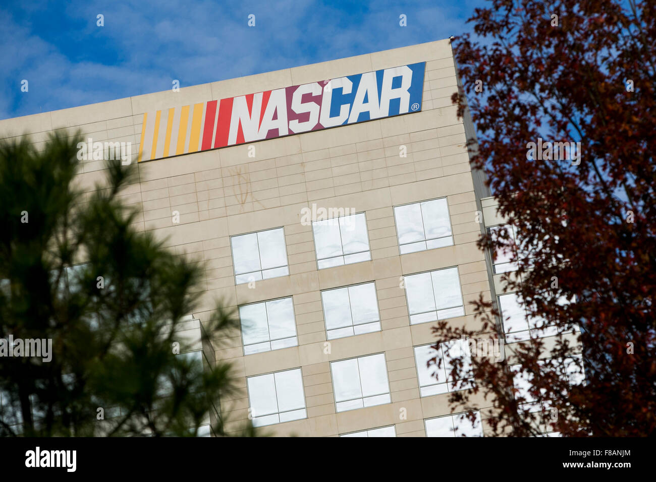 A logo sign outside of a facility occupied by the National Association for Stock Car Auto Racing (NASCAR) in Charlotte, North Ca Stock Photo