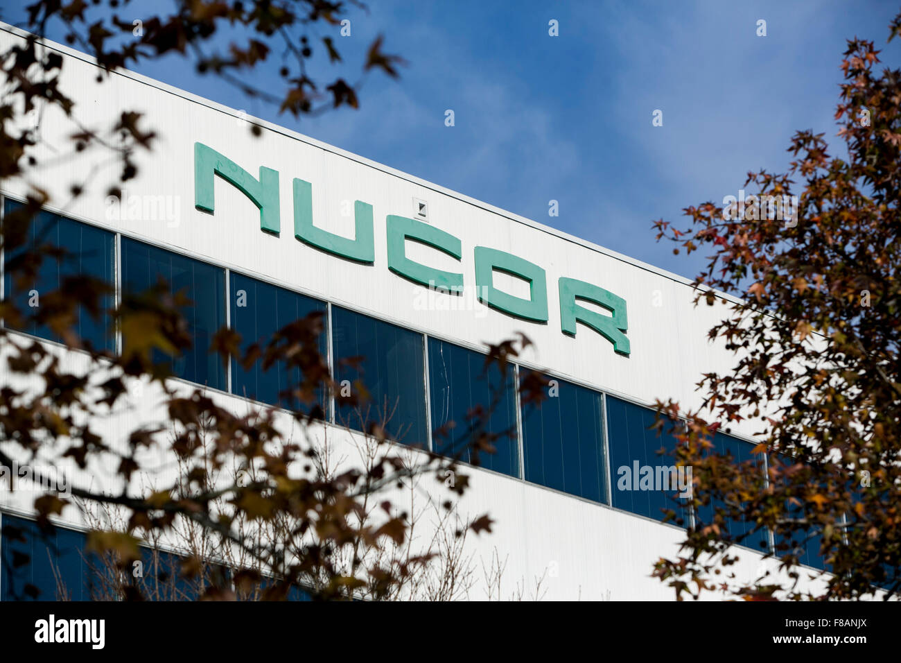 A logo sign outside of the headquarters of the Nucor Corporation in
