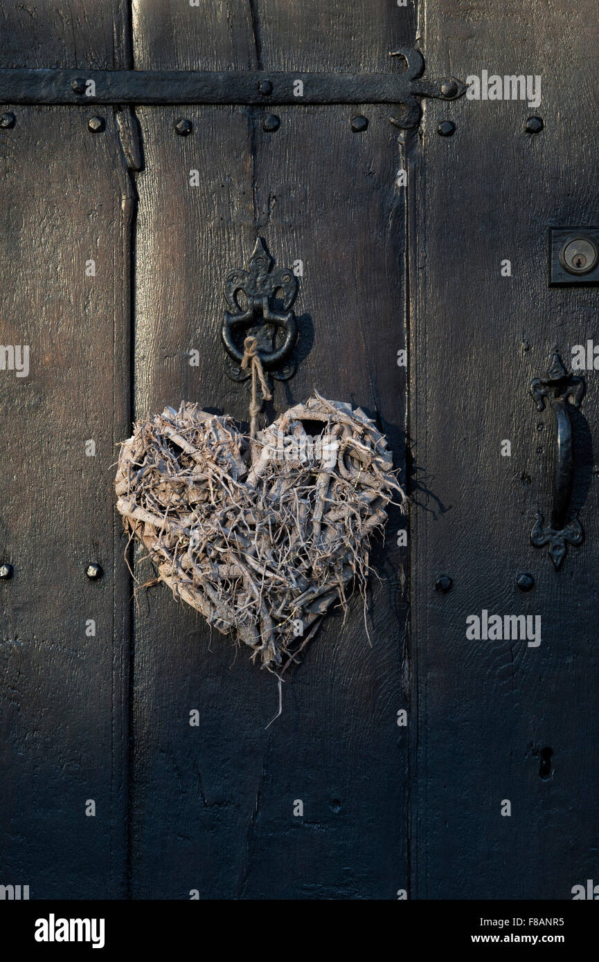 Craft Wooden heart on an old oak front door Stock Photo