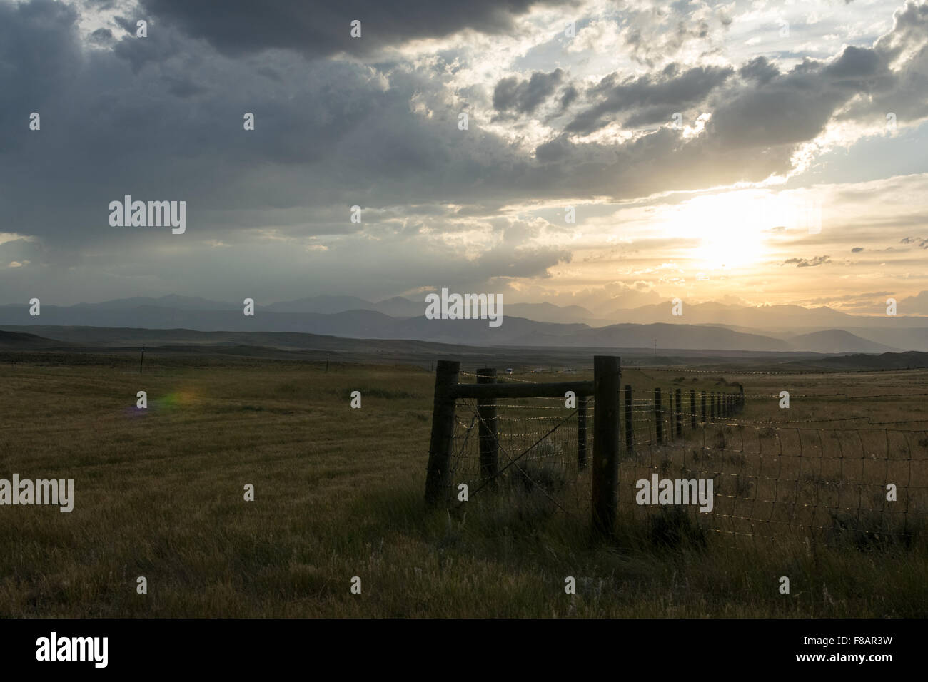 Sun setting behind wooden hi-res stock photography and images - Alamy