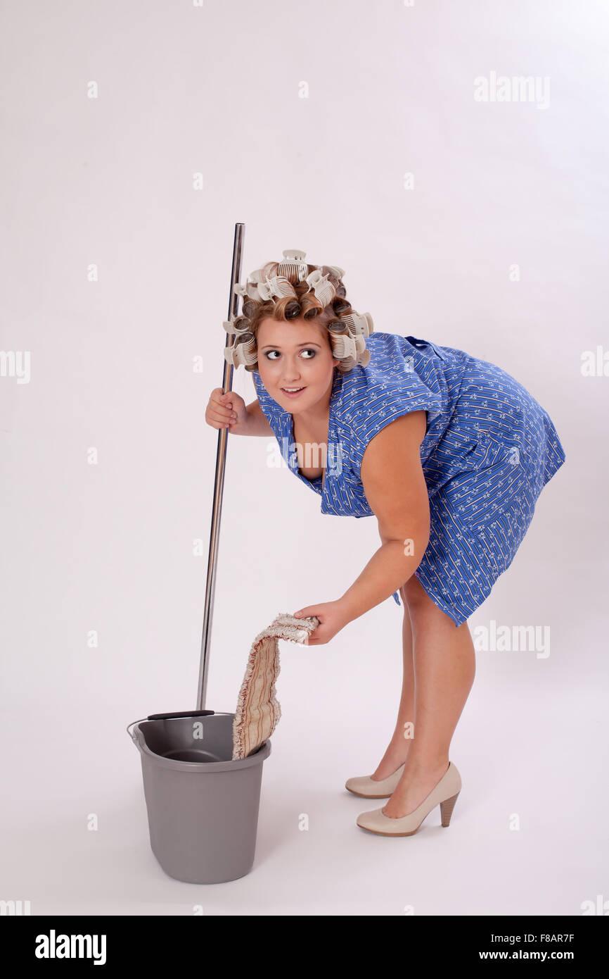Funny Female Cleaner Holding Cleaning Materials Stock Photo