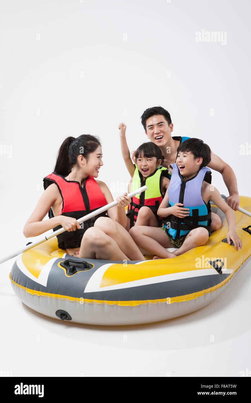 Happy family in life jackets riding on a boat Stock Photo Alamy