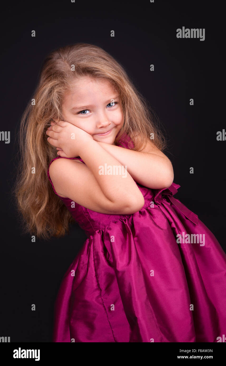 Portrait of a cute little girl in a pink dress in the studio Stock ...