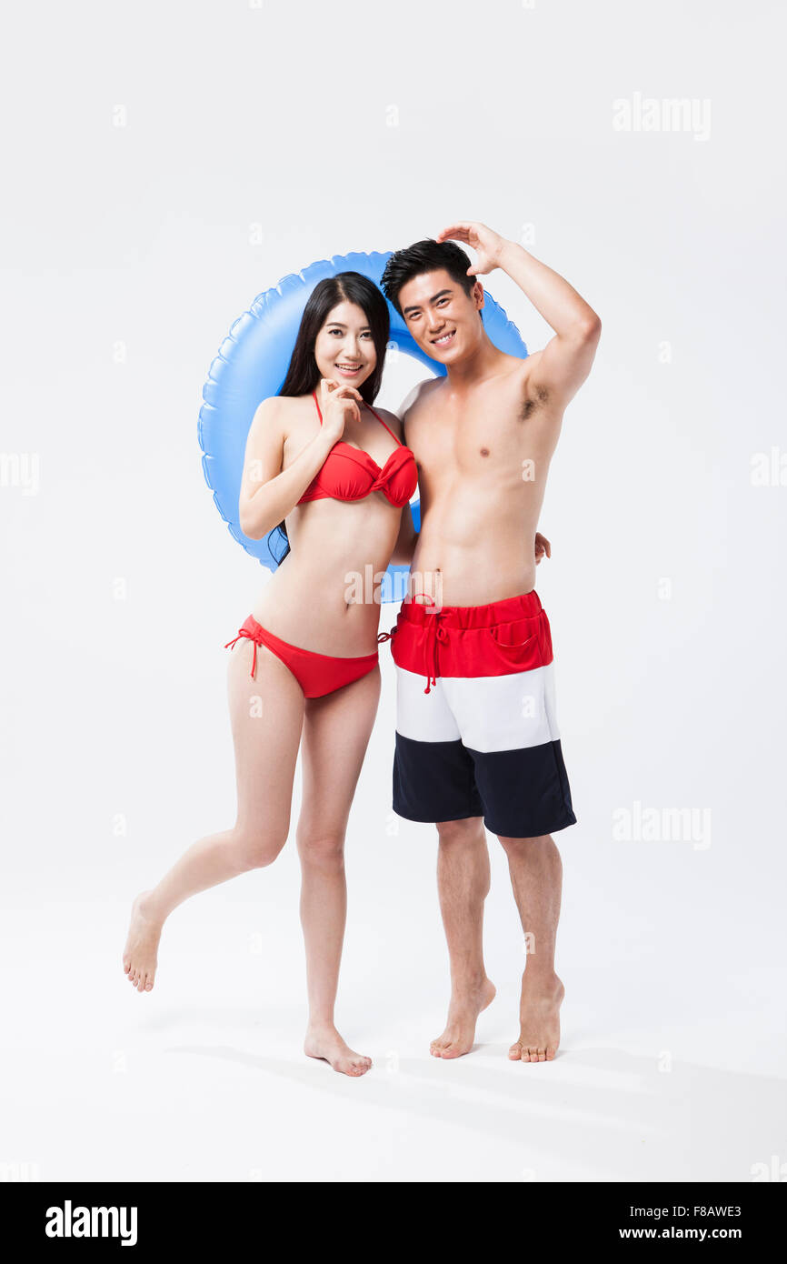 Couple in swimsuits posing with a tube Stock Photo