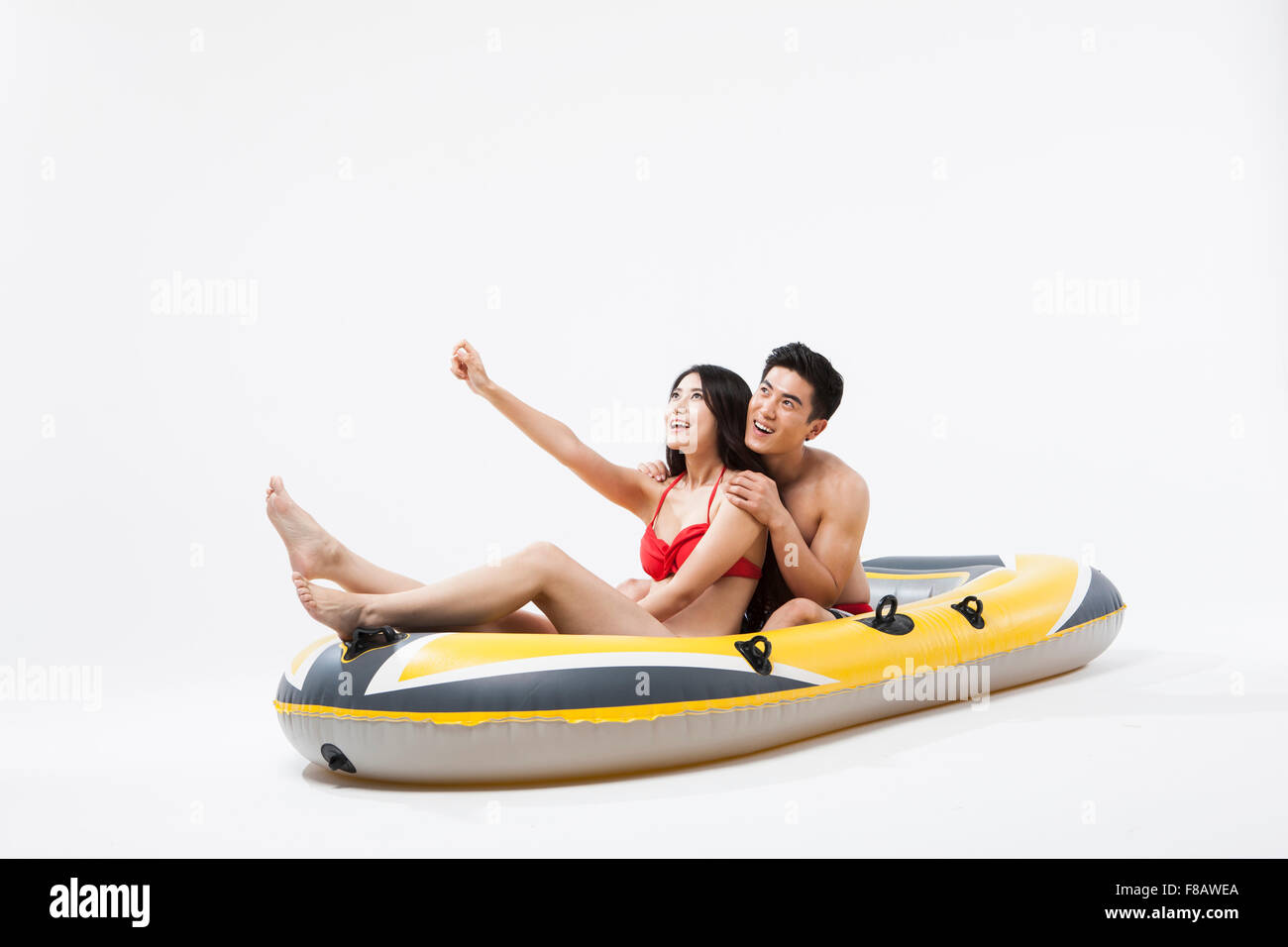 Couple enjoying ride a banana boat looking up Stock Photo