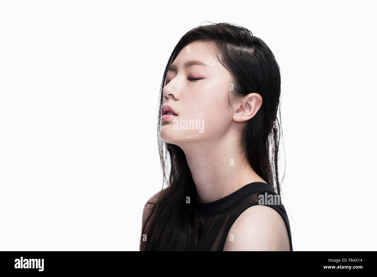 Side view potrait of young woman closing eyes Stock Photo