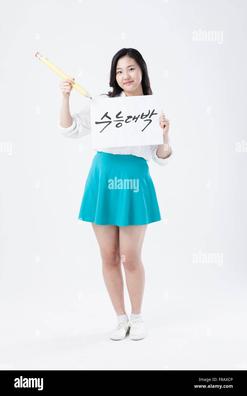 Korean highschool girl standing and showing cheering message for national college entrance exam Stock Photo