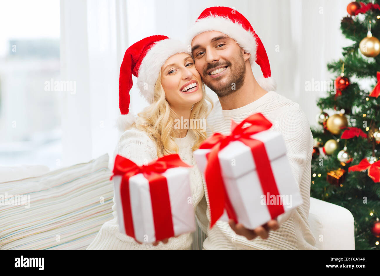 happy couple at home with christmas gift boxes Stock Photo - Alamy