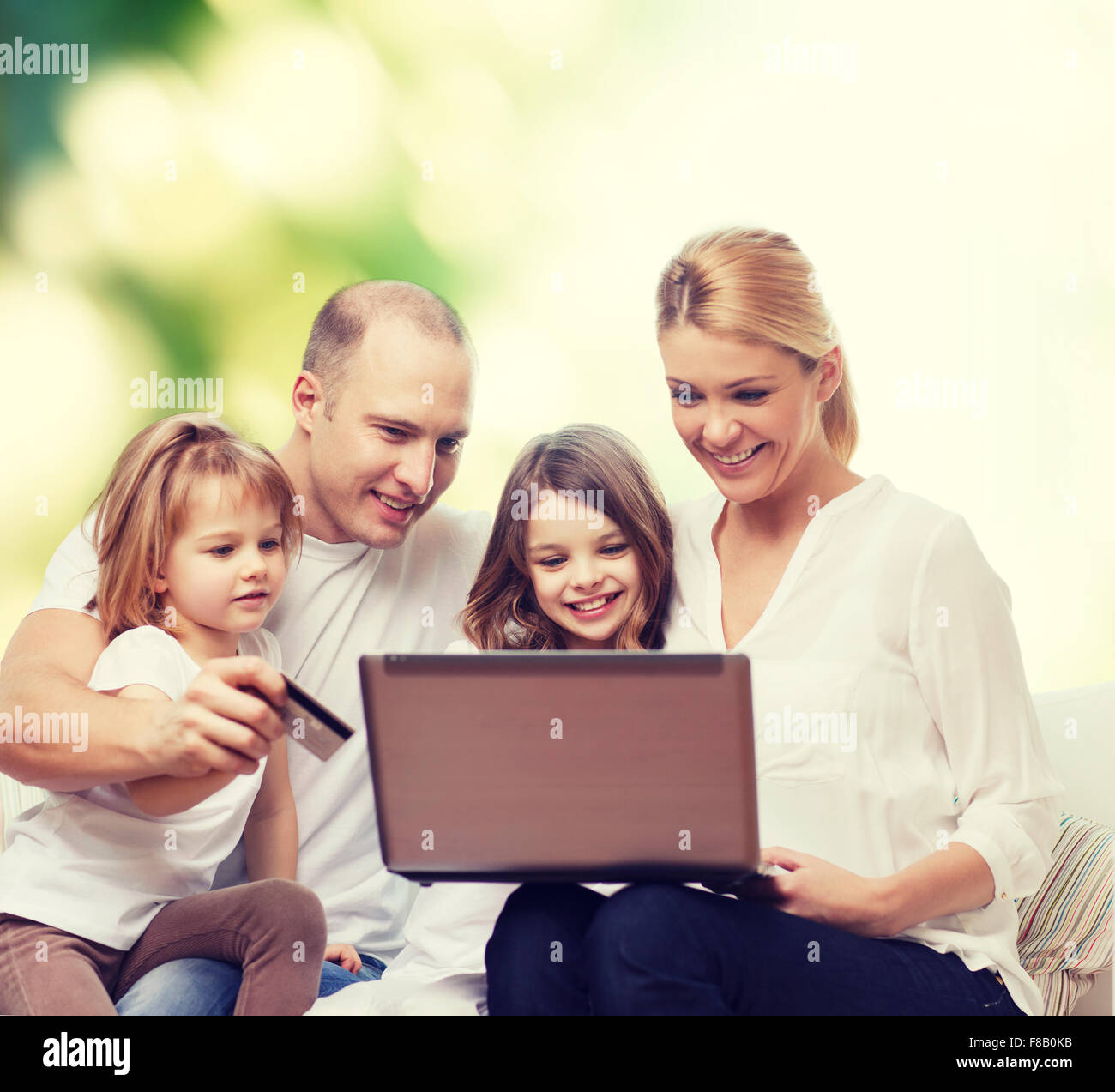 happy family with laptop computer and credit card Stock Photo - Alamy