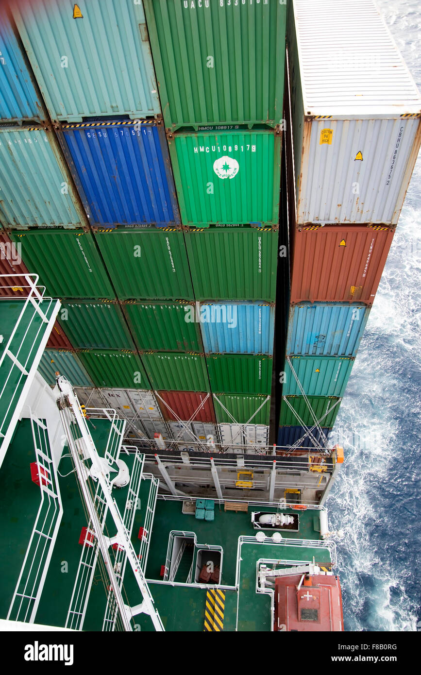 View of stacked containers in the stern of Corte Real ship from high up on the Bridge. Stock Photo