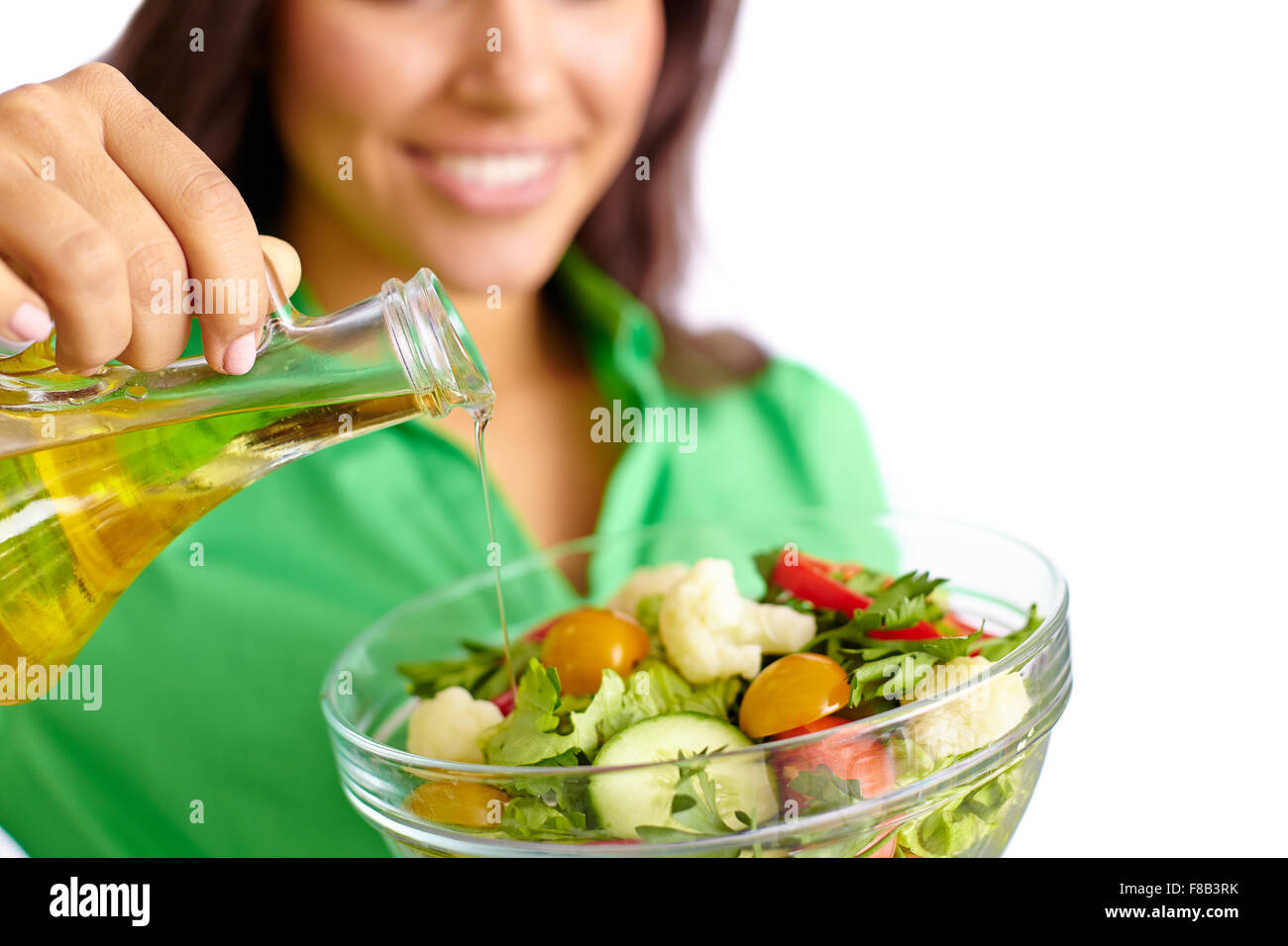Adding Fresh Oil Female adding olive oil into fresh vegetable salad Stock Photo - Alamy