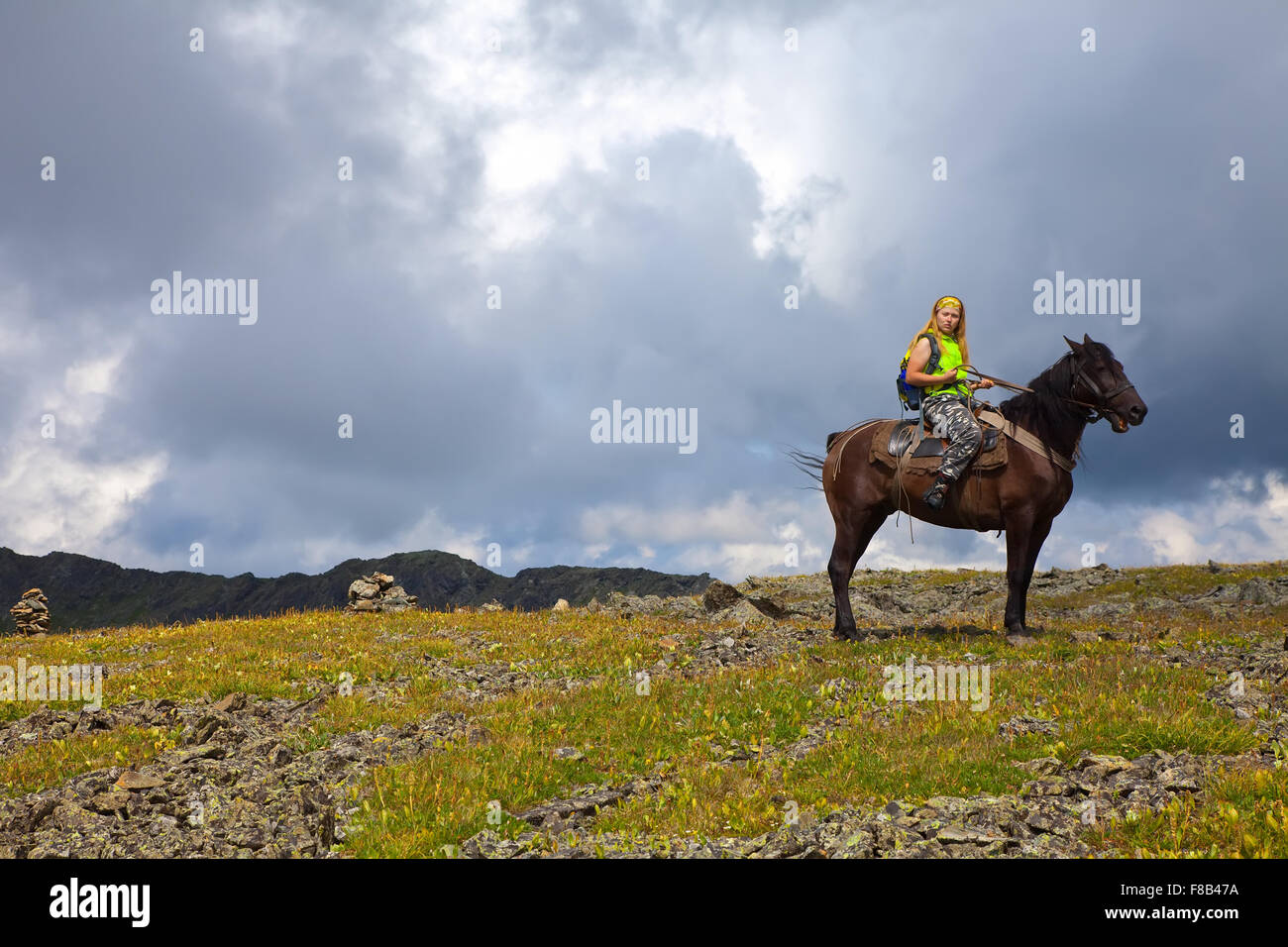 lone rider on horseback at mountains Stock Photo Alamy