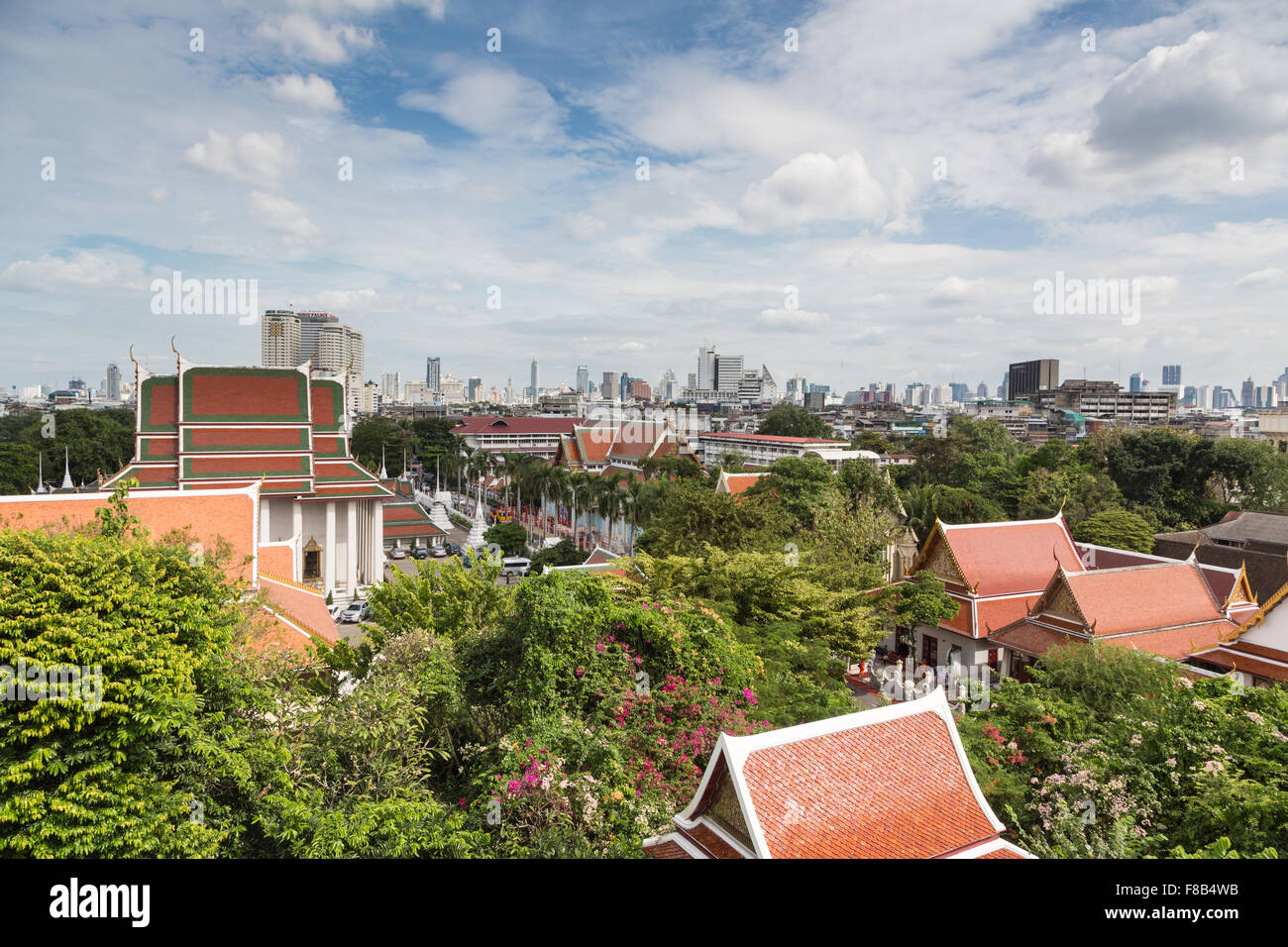 A Bangkok cityscape mixing traditional Buddhist temples and modern buildings in the background in Thailand capital city Stock Photo