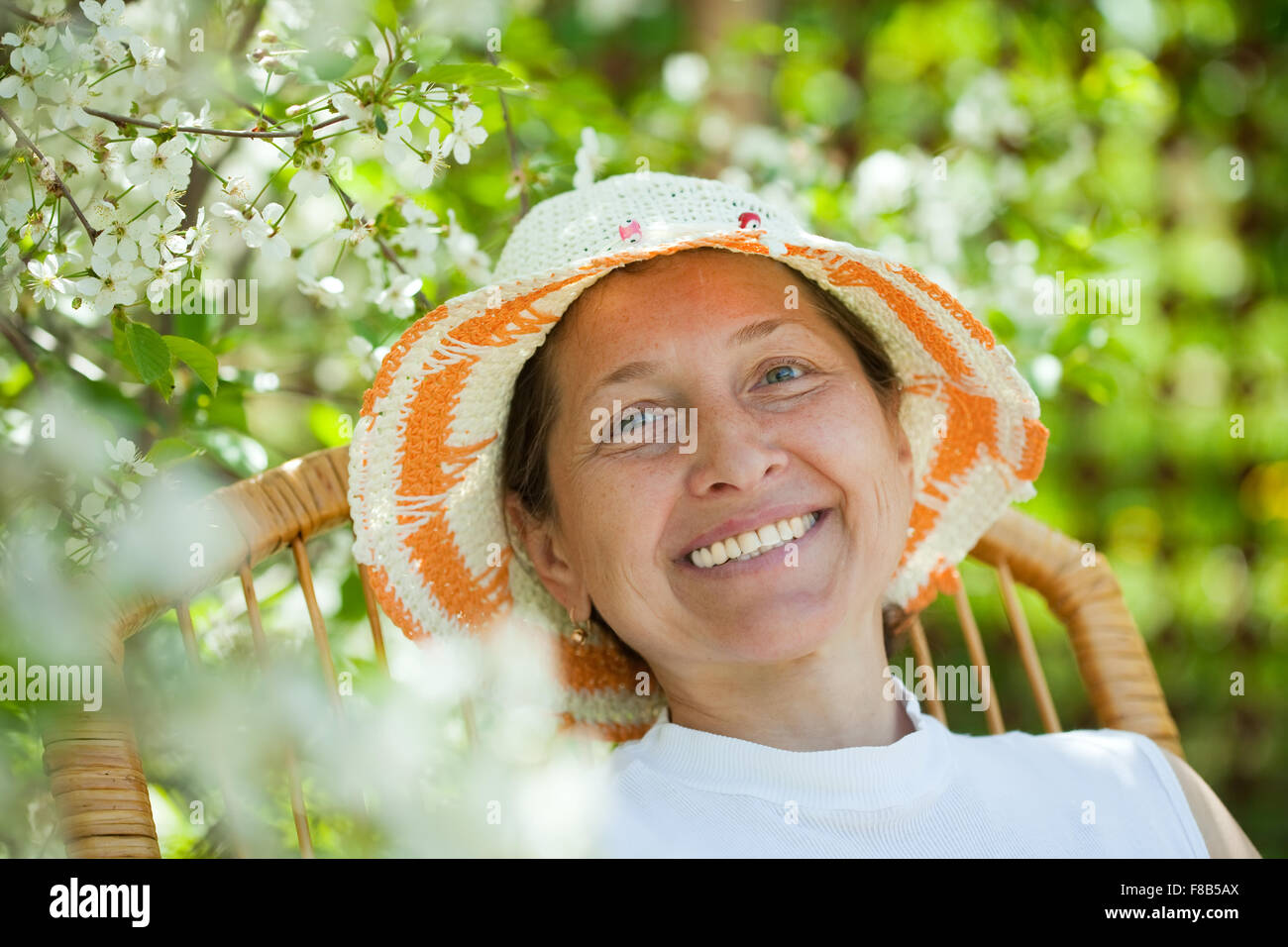 portrait of mature woman in the blossoming garden Stock Photo - Alamy
