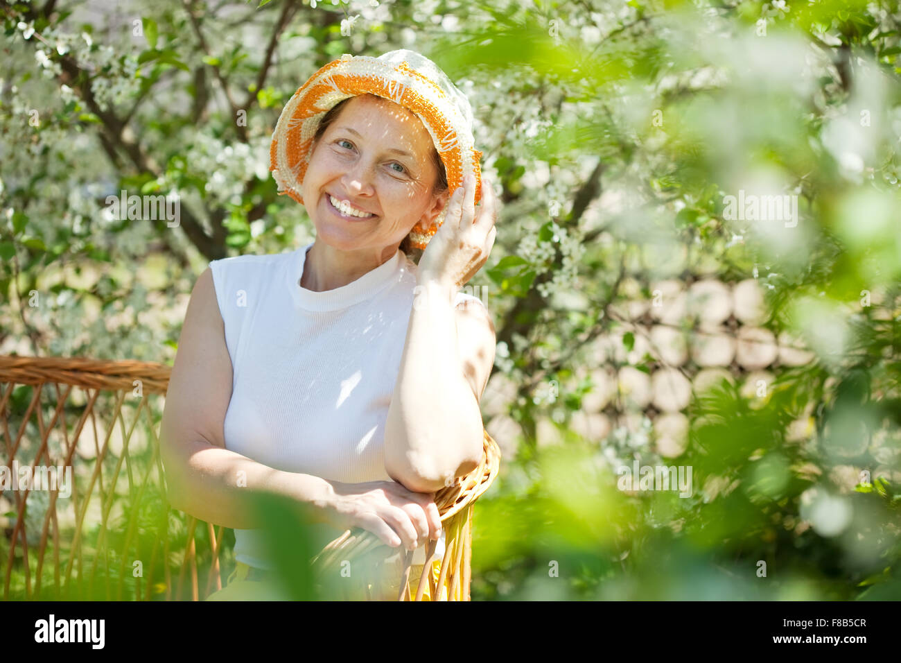 Happy mature woman relaxing in blossoming garden Stock Photo - Alamy
