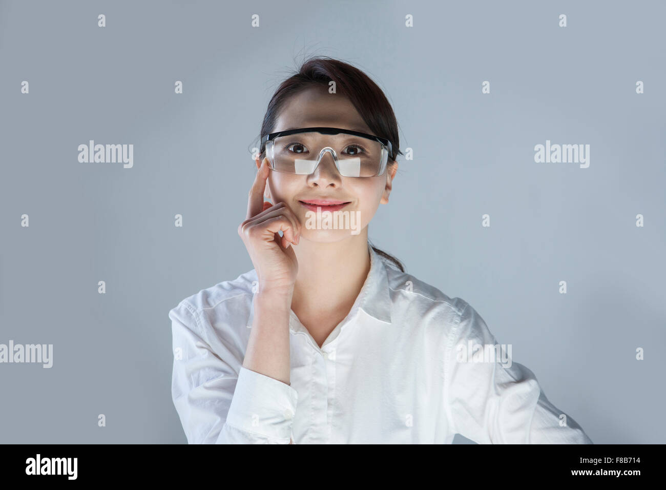 Business woman wearing goggles and staring forward with a smile Stock Photo