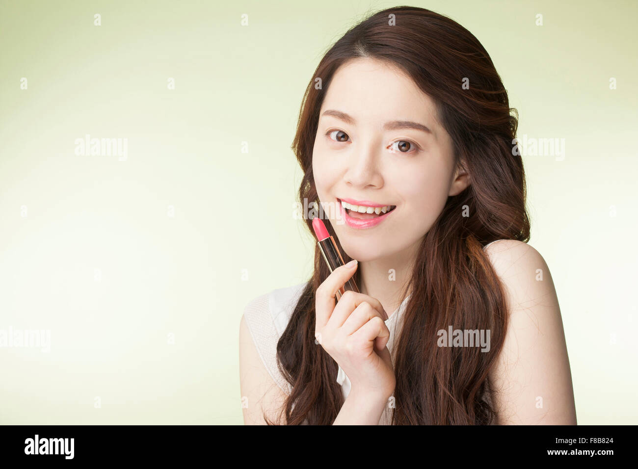 Korean Woman With Long Wavy Hair In White Sleeveless Shirt Smiling