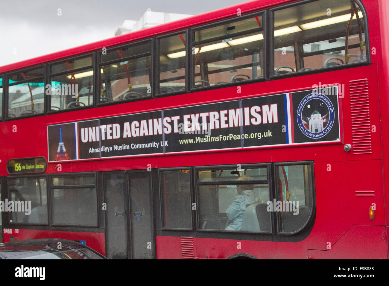 Wimbledon, London, UK. 08th Dec, 2015. A red double decker bus advertises 'United Against Extremism' by the Ahmadiyya Muslim community in the wake of the French Paris attacks  and London tube stabbing Credit:  amer ghazzal/Alamy Live News Stock Photo