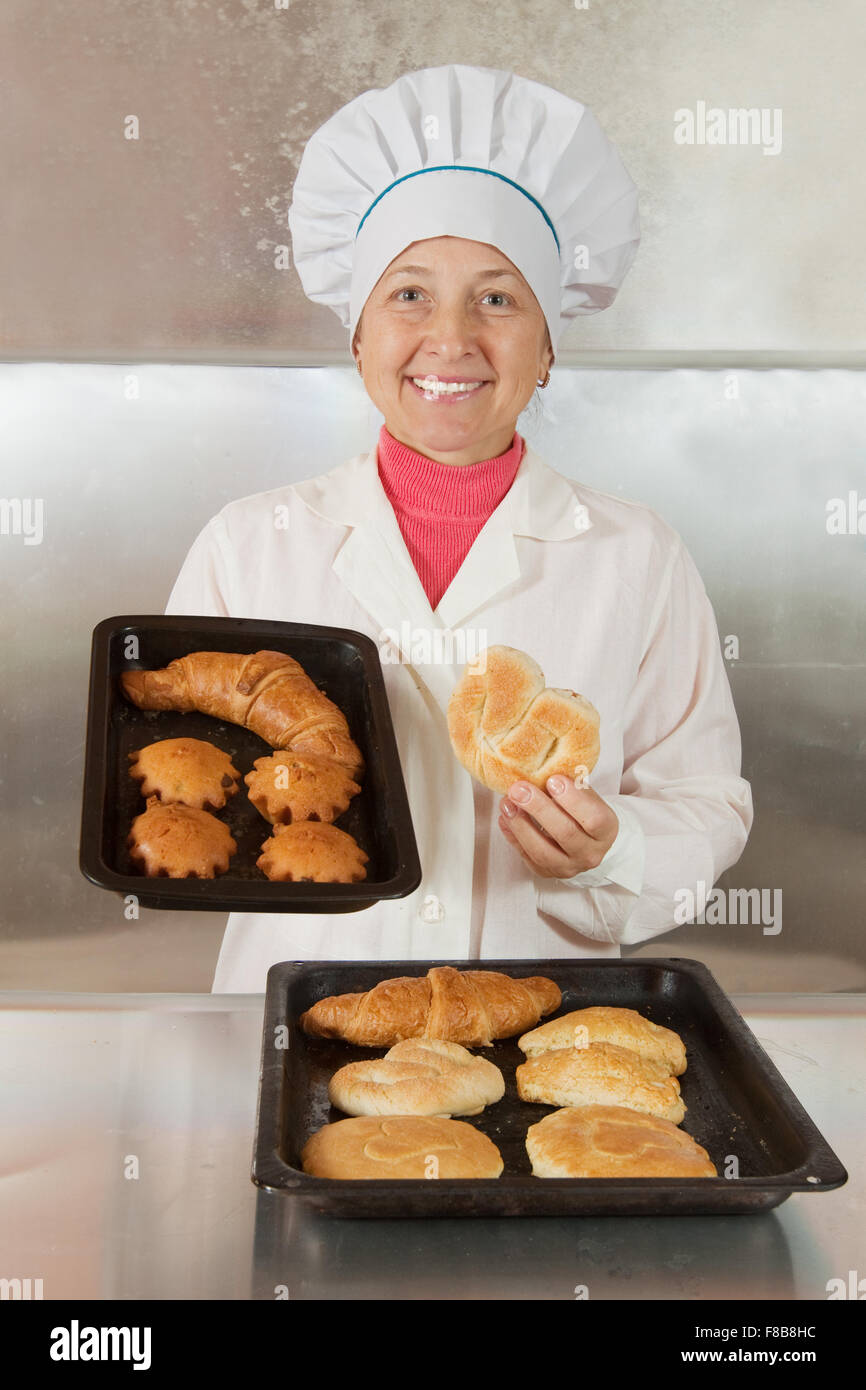 Baker with fresh pastries at bakery Stock Photo Alamy