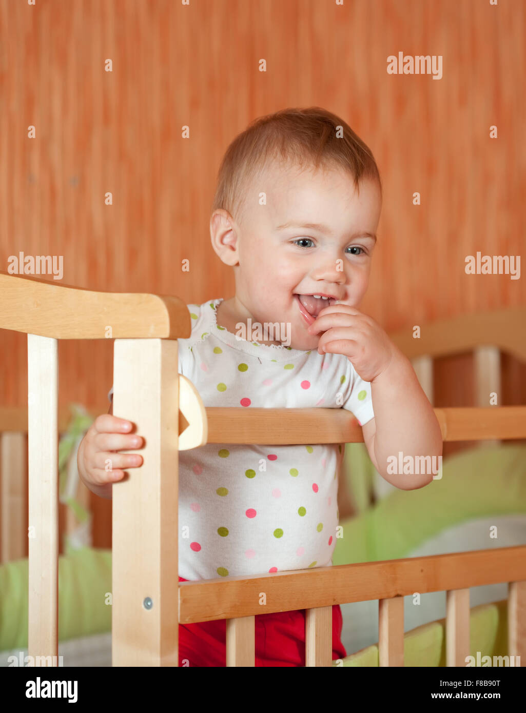 Happy baby of one year old in crib Stock Photo - Alamy