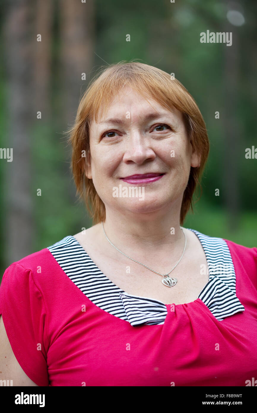 Outdoor portrait of smiling mature woman Stock Photo - Alamy