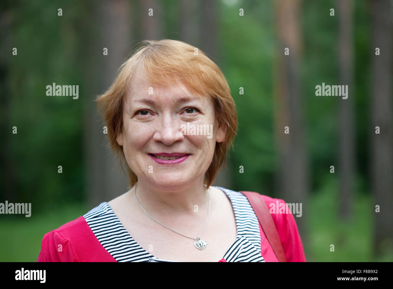 Outdoor portrait of smiling mature woman Stock Photo - Alamy
