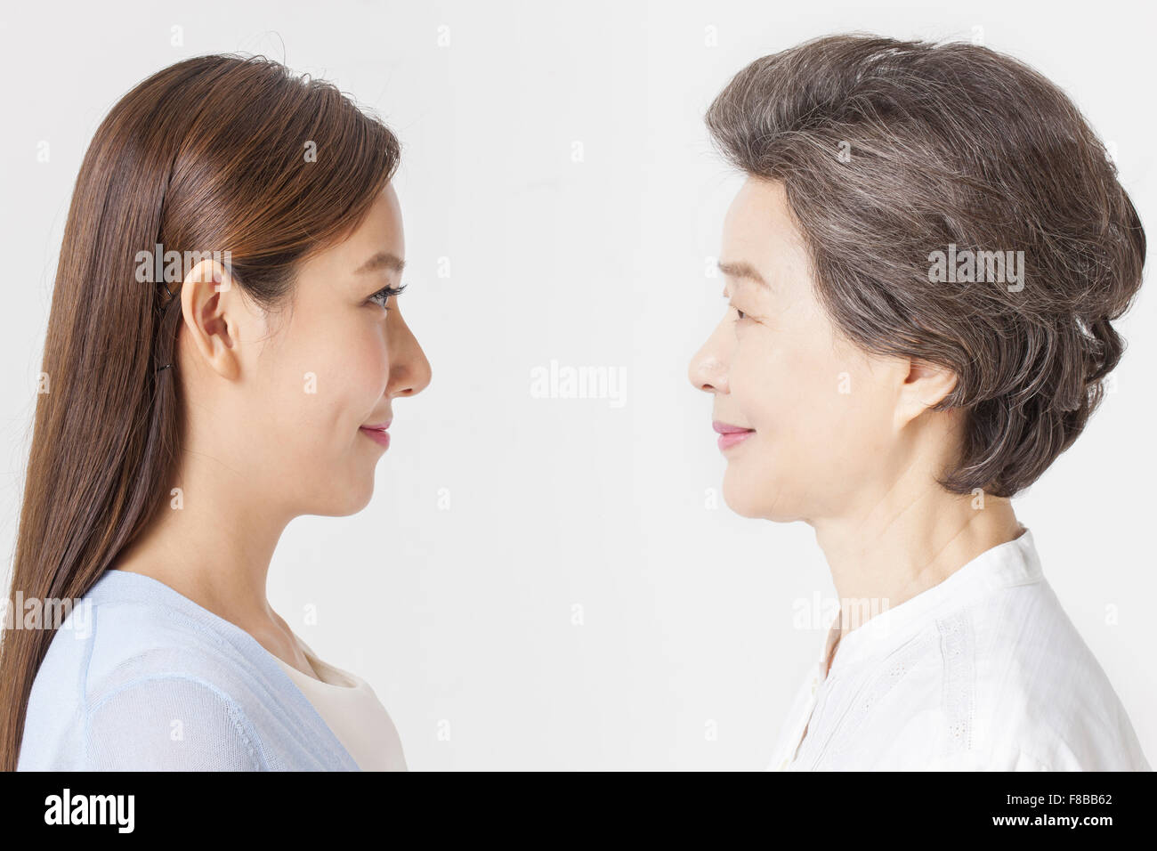 Mother and grown up daughter looking at each other Stock Photo