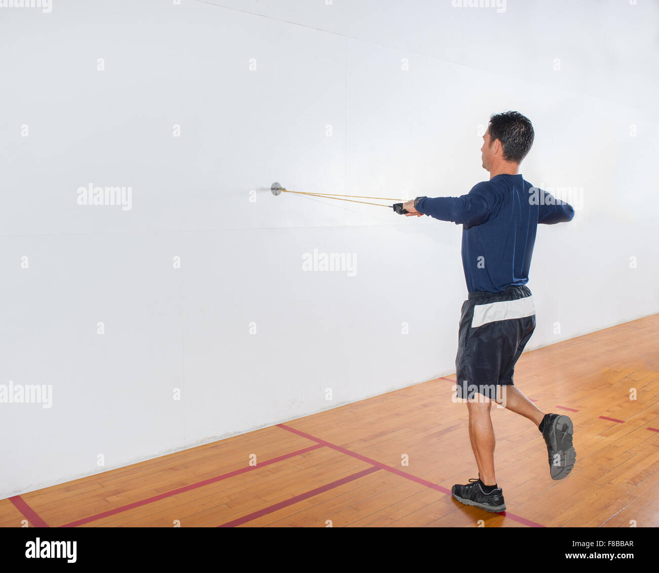 Middle age man showing resistance band exercise for balance and the