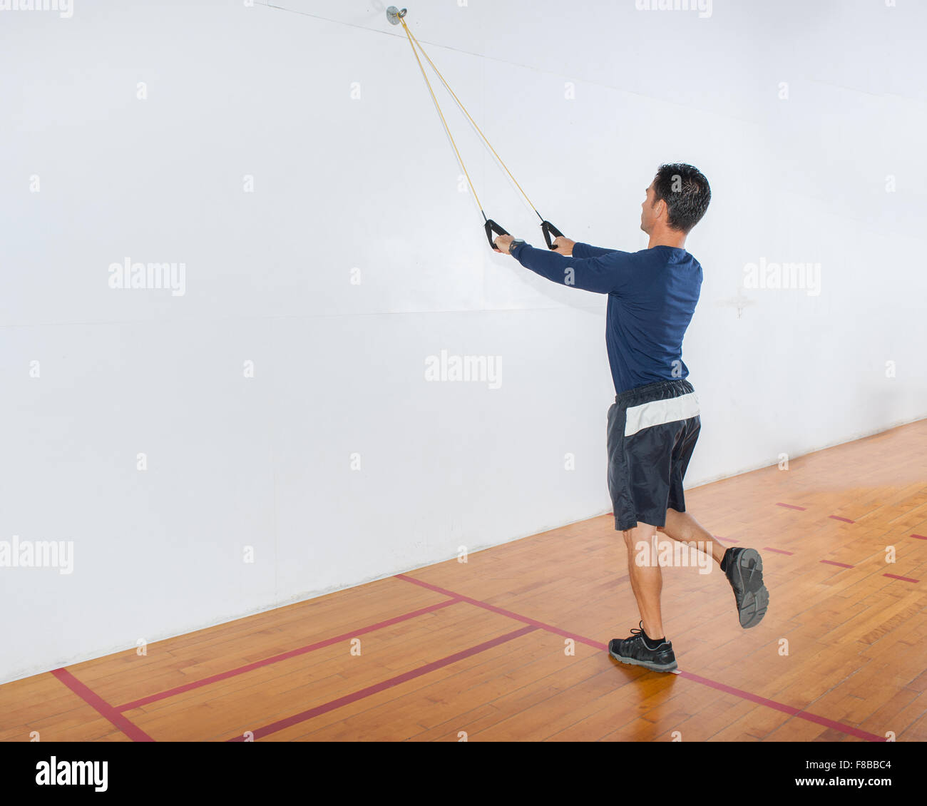 Middle age man showing resistance band exercise for the lats and