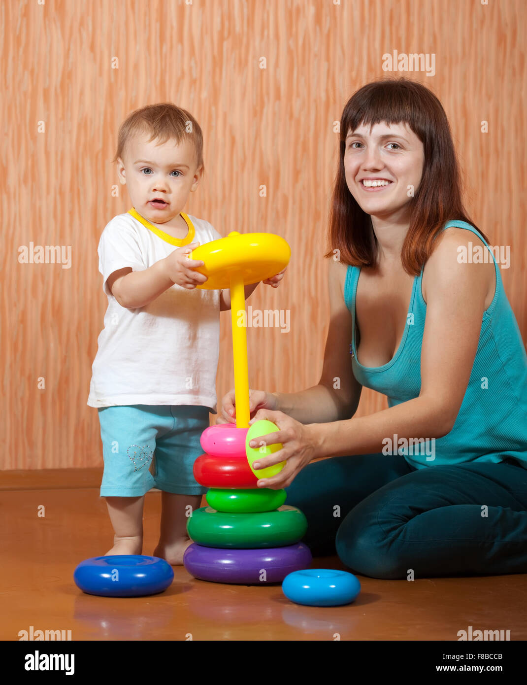 Happy mother and baby plays with pyramidion Stock Photo - Alamy