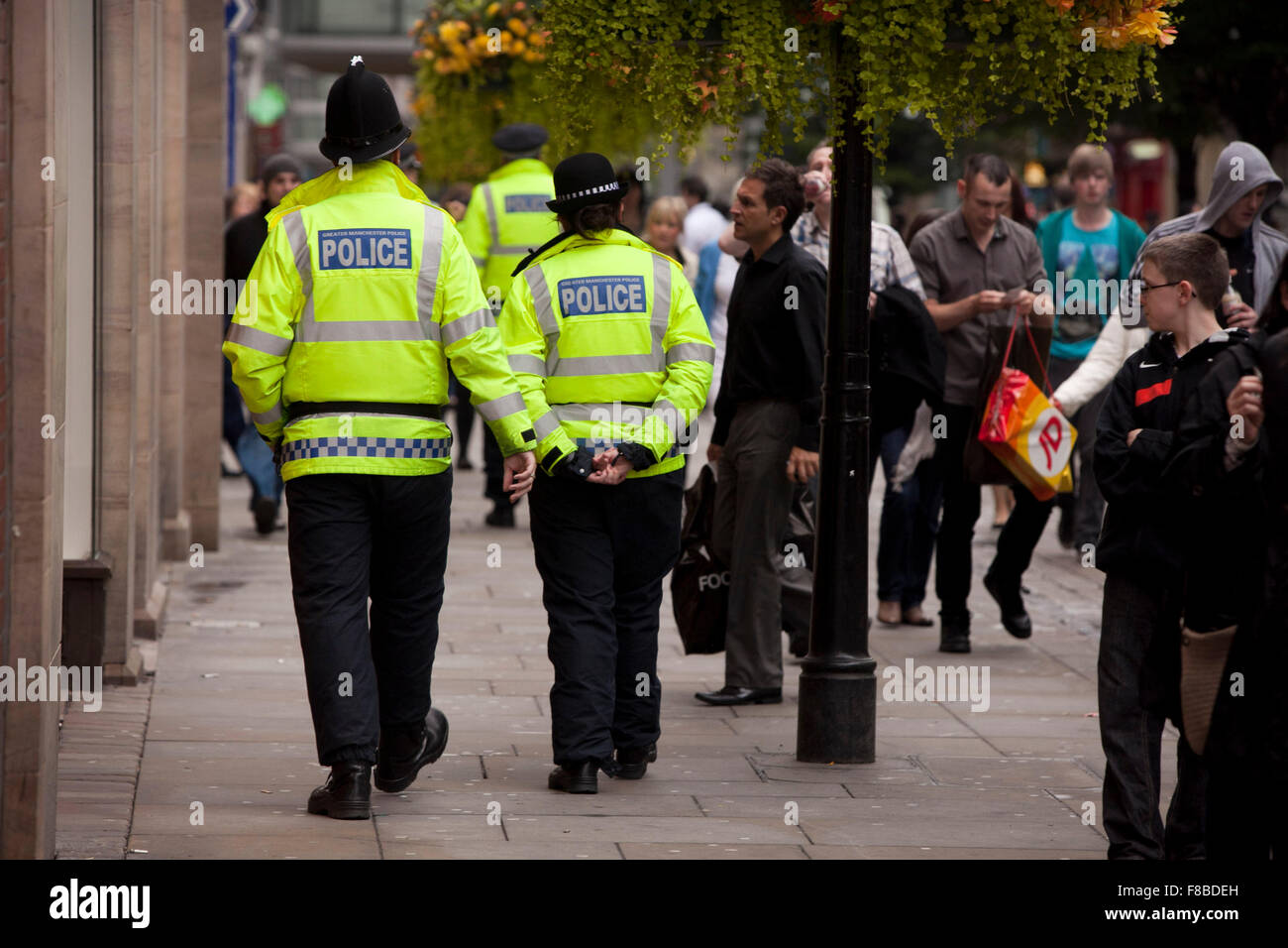 Police patrol the streets of Manchester three nights after riots hit the city . Stock Photo