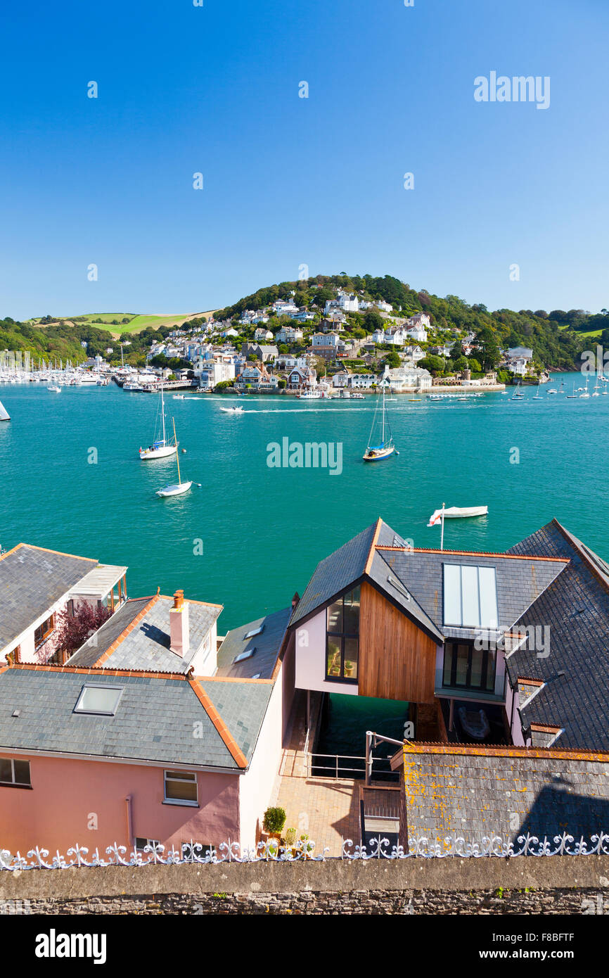 Looking out across the modern expensive waterfront houses on the River Dart towards Kingswear from Dartmouth, Devon, England, UK Stock Photo