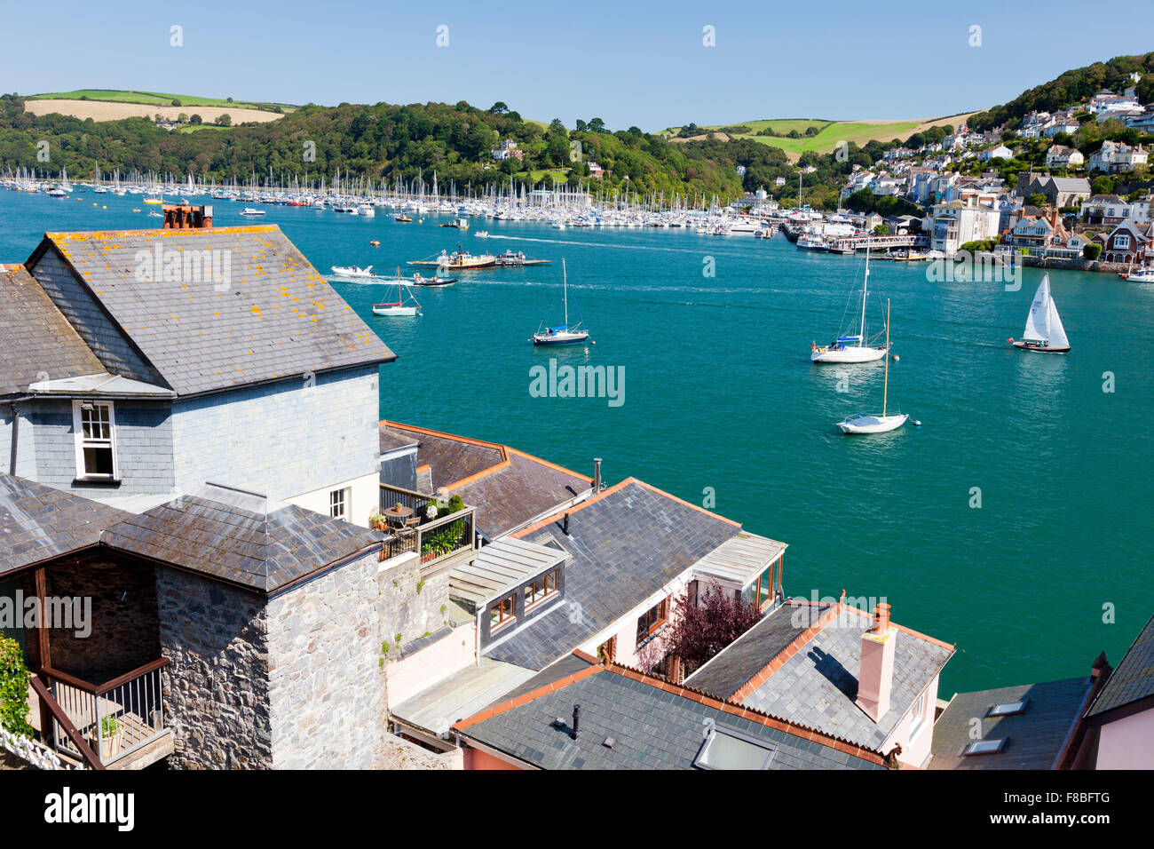 Looking out across the expensive waterfront houses on the River Dart towards Kingswear from Dartmouth, Devon, England, UK Stock Photo
