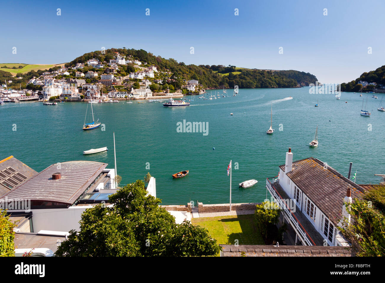 Looking out across the expensive waterfront houses on the River Dart towards Kingswear from Dartmouth, Devon, England, UK Stock Photo