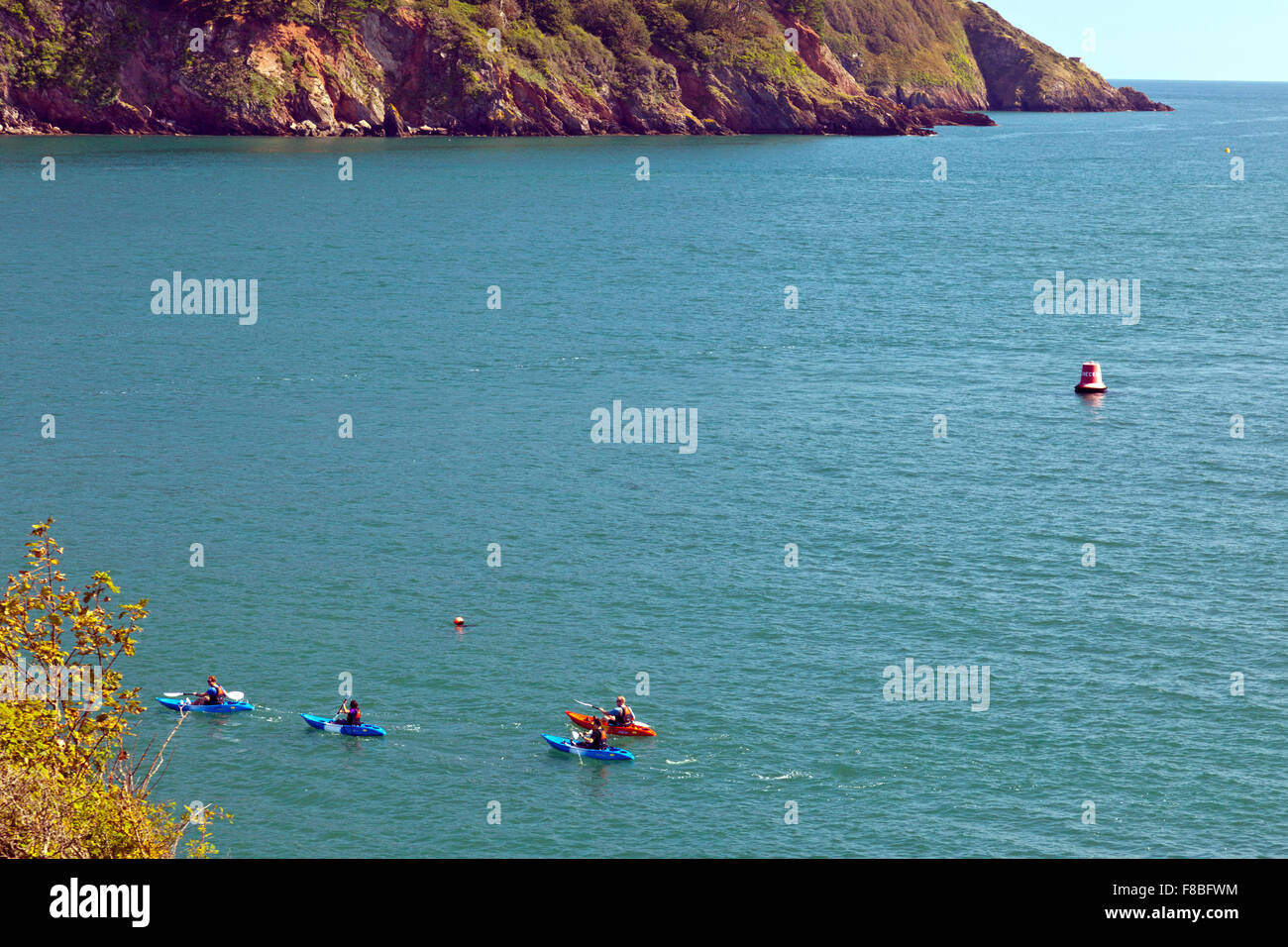Sea kayakers entering the mouth of the River Dart near Dartmouth, Devon, England, UK Stock Photo