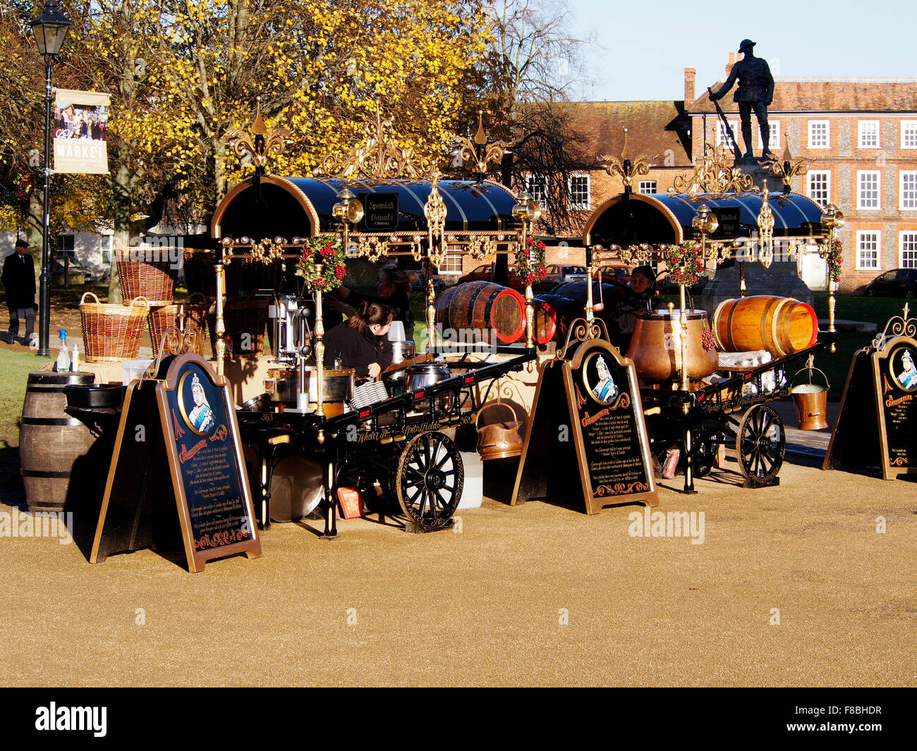 Costermonger's style carts at Winchester Cathedral Christmas Market in December 2015 selling donuts and mulled wine. Stock Photo