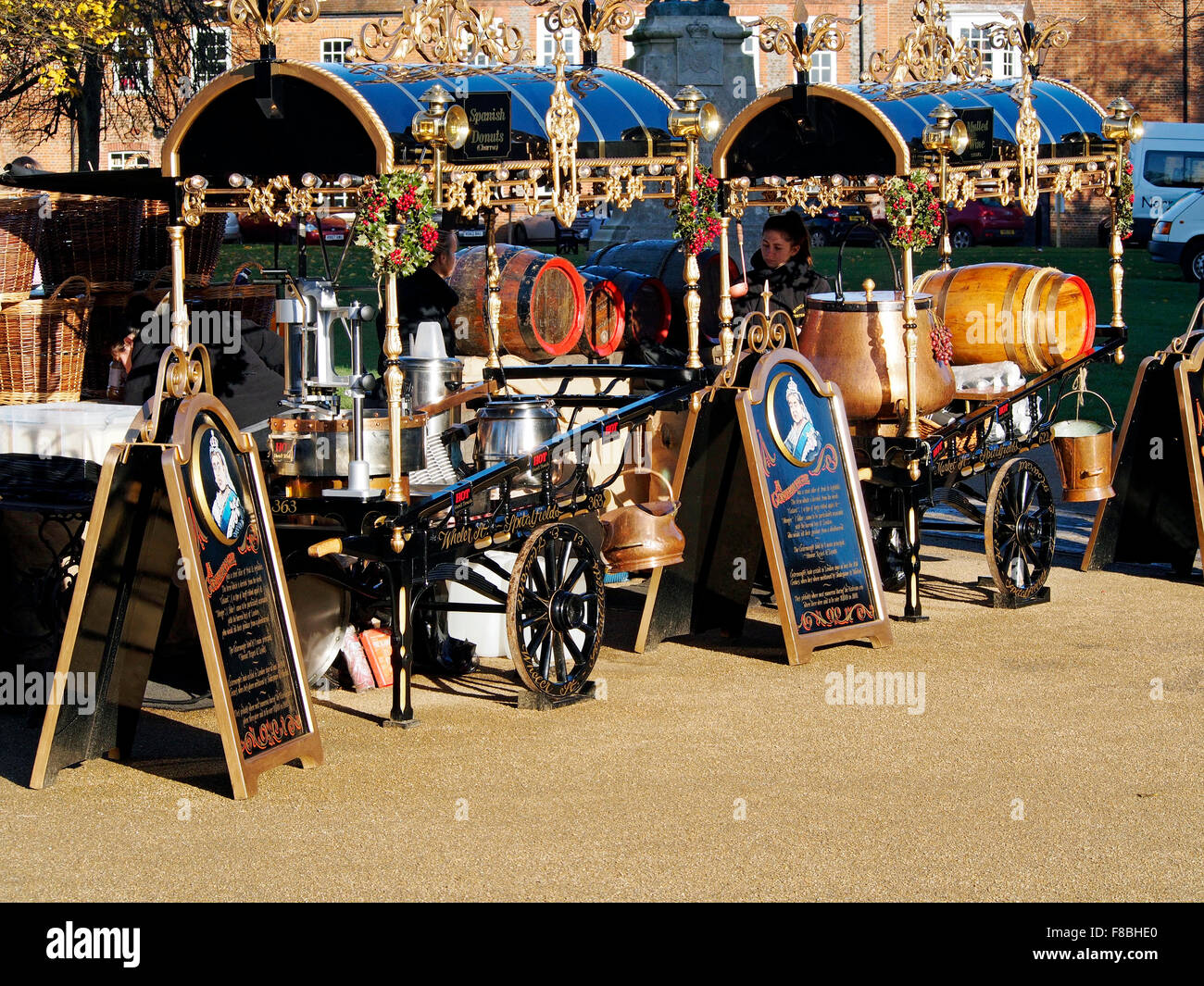 Costermonger's style carts at Winchester Cathedral Christmas Market in December 2015 selling donuts and mulled wine. Stock Photo