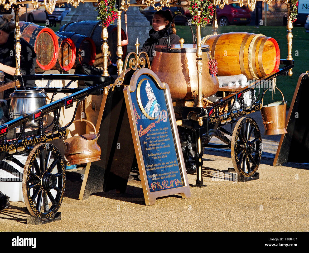 Costermonger's style carts at Winchester Cathedral Christmas Market in December 2015 selling donuts and mulled wine. Stock Photo