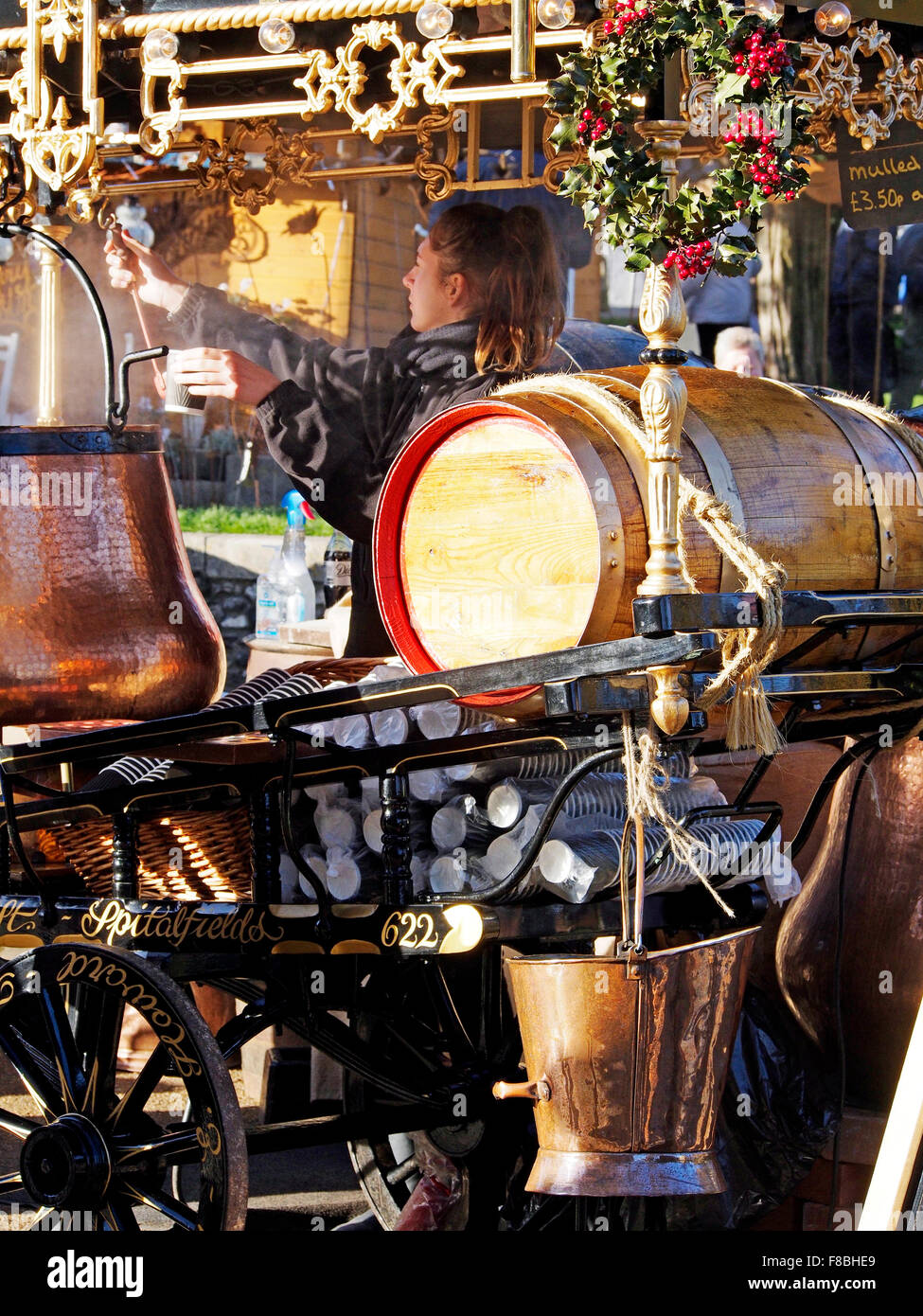 Women selling mulled wine from a costermonger style cart at Winchester Cathedral Christmas Market in December 2015 Stock Photo
